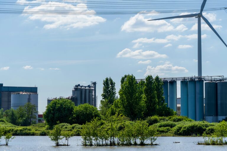 Industrial landscape with wind turbine and water